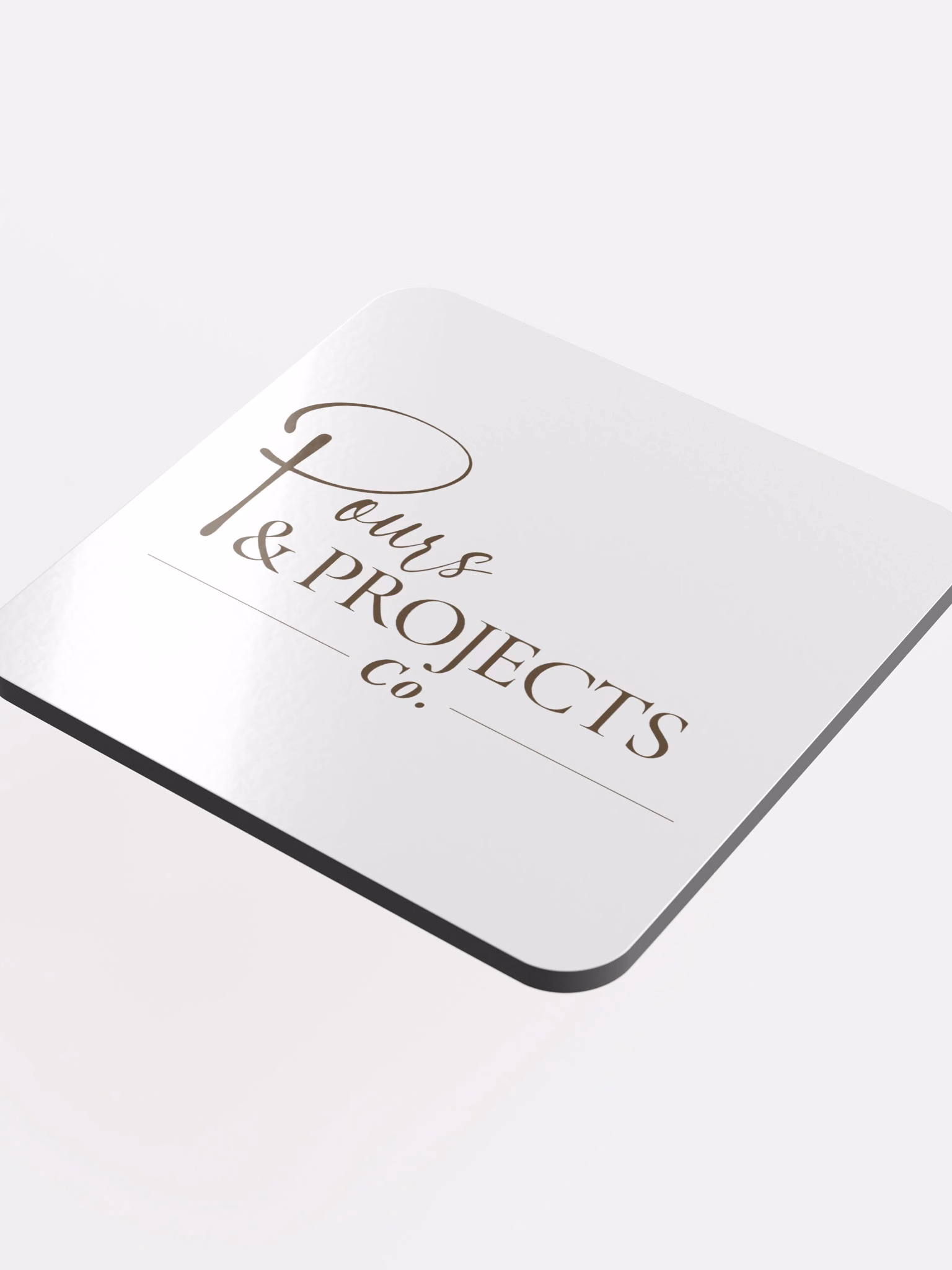White coaster with the Pours & Projects Co. script logo